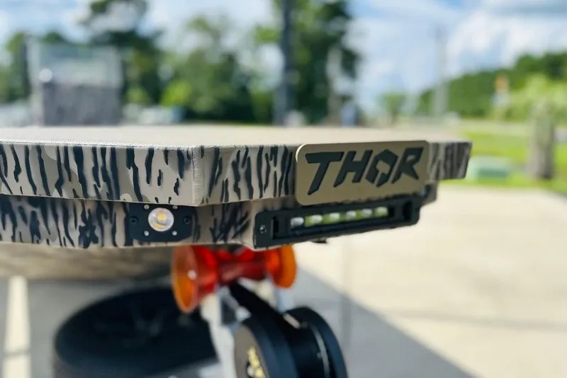 Slide: The Image of Close-up of 2025 Thor 1900 Lake Hammer boat with camouflage design and logo. - 11