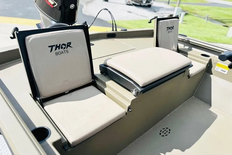 Slide: The Image of 2025 Thor 1900 Lake Hammer boat seats with logo, beige upholstery, and cup holders. - 3