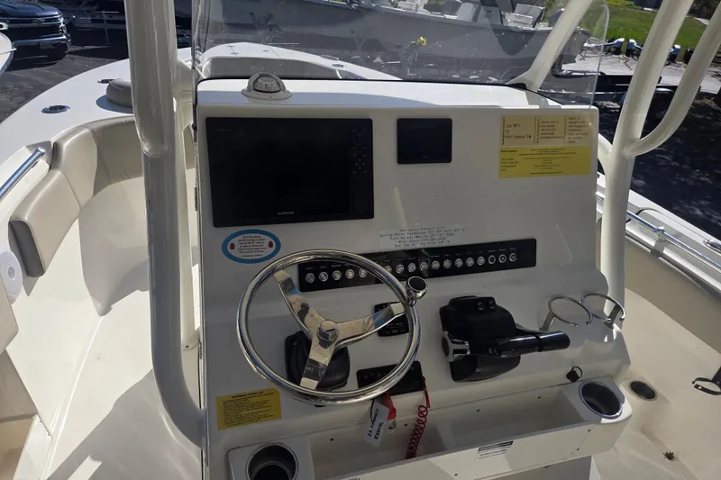 Slide: The Image of 2023 Key West 263 FS boat dashboard with steering wheel and controls. - 12
