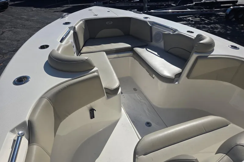 Slide: The Image of 2023 Key West 263 FS boat interior with cushioned seating and cup holders. - 14