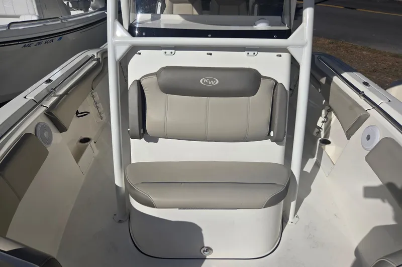 Slide: The Image of 2023 Key West 263 FS boat interior with cushioned seating and console. - 15