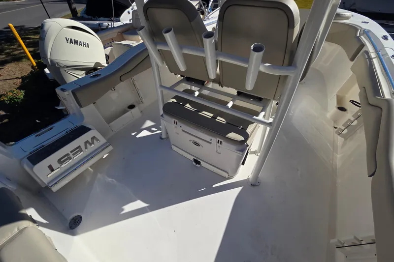 Slide: The Image of 2023 Key West 263 FS boat interior with Yamaha engine, featuring seating and storage. - 17