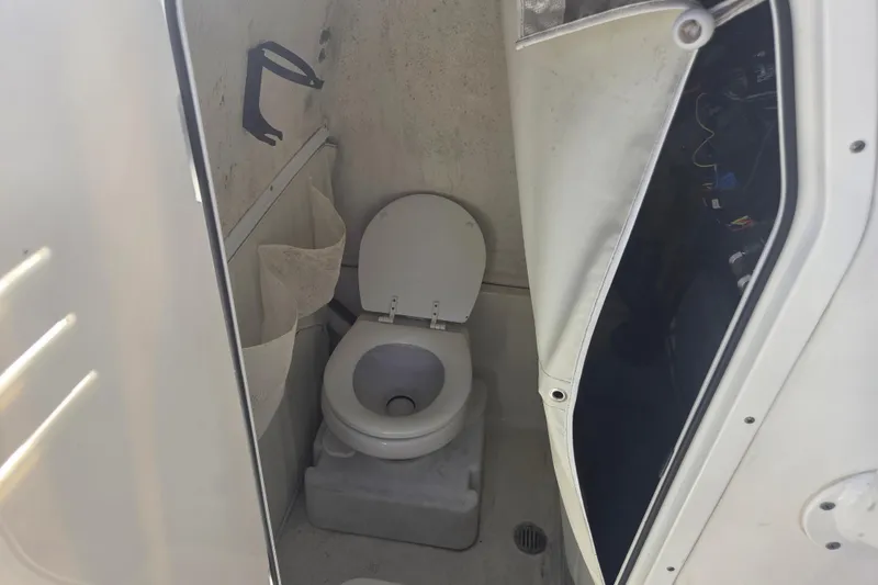 Slide: The Image of 2023 Key West 263 FS boat interior with compact marine toilet. - 19