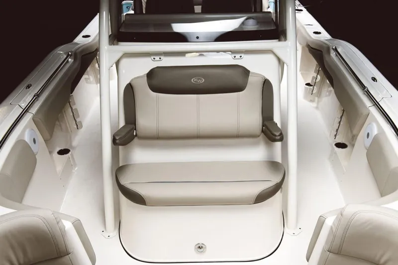 Slide: The Image of 2023 Key West 263 FS boat on trailer, parked outdoors, surrounded by trees. - 4