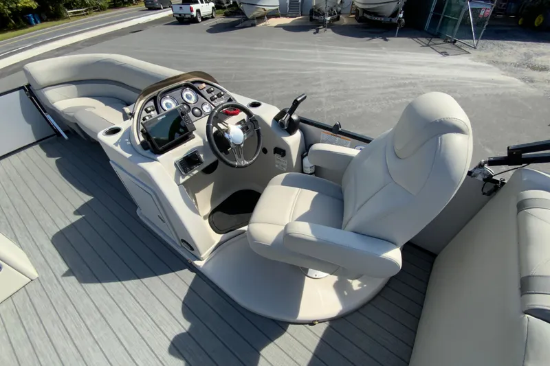 Slide: The Image of 2019 SunChaser Geneva Cruise 24 LR DH Sport boat interior with captain's chair and control panel. - 15