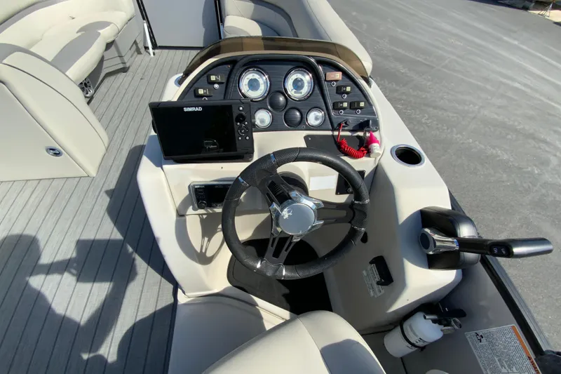 Slide: The Image of 2019 SunChaser Geneva Cruise 24 LR DH Sport boat dashboard with steering wheel and controls. - 16
