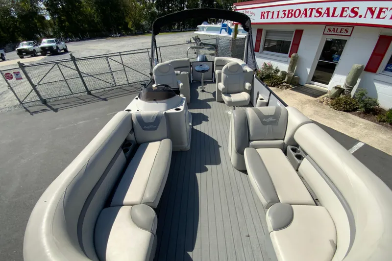 Slide: The Image of 2019 SunChaser Geneva Cruise 24 LR DH Sport pontoon boat with spacious seating at a sales lot. - 20