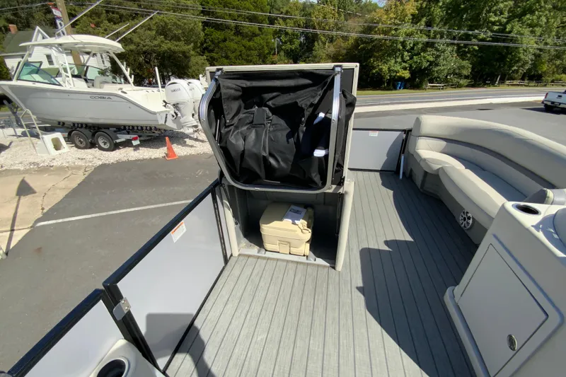 Slide: The Image of 2019 SunChaser Geneva Cruise 24 LR DH Sport pontoon interior with seating and storage. - 21