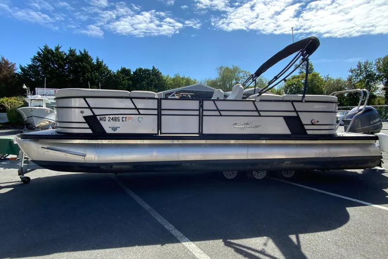 Slide: The Image of 2019 SunChaser Geneva Cruise 24 LR DH Sport pontoon boat parked outdoors. - 5