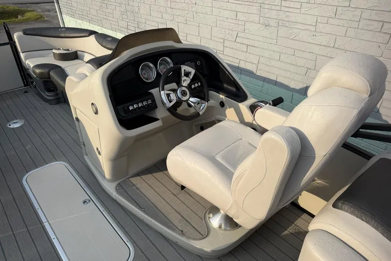 Slide: The Image of 2020 Avalon 2385 Catalina Quad Lounger boat interior with steering console and seating. - 9