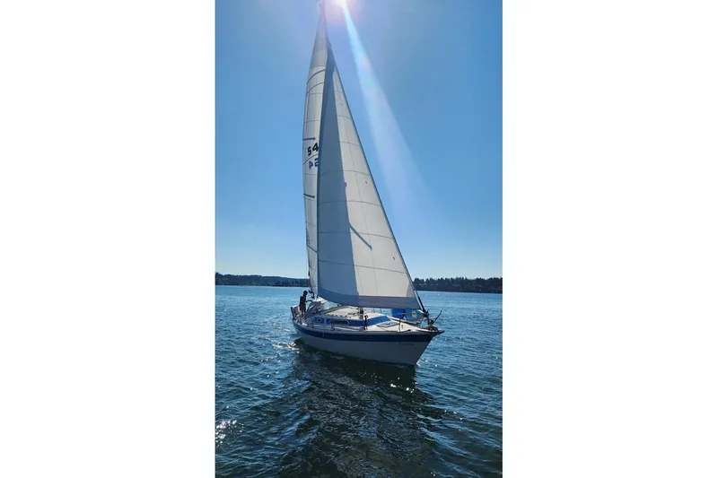 Slide: The Image of 1985 Dehler 372 sailboat gliding on a sunny day with full sails. - 1