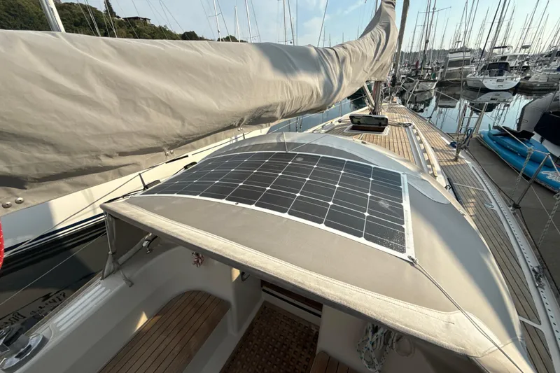 Slide: The Image of 1985 Dehler 372 sailboat with solar panel, docked in a marina. - 17