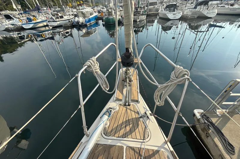 Slide: The Image of Dehler 372 sailboat from 1985 docked in a marina, surrounded by other boats. - 19