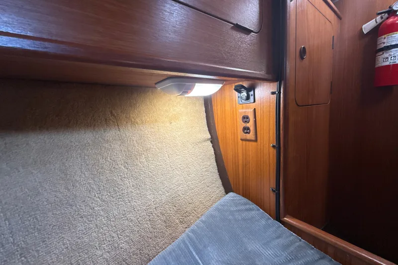 Slide: The Image of Interior cabin of 1985 Dehler 372 sailboat with wood paneling and lighting. - 25