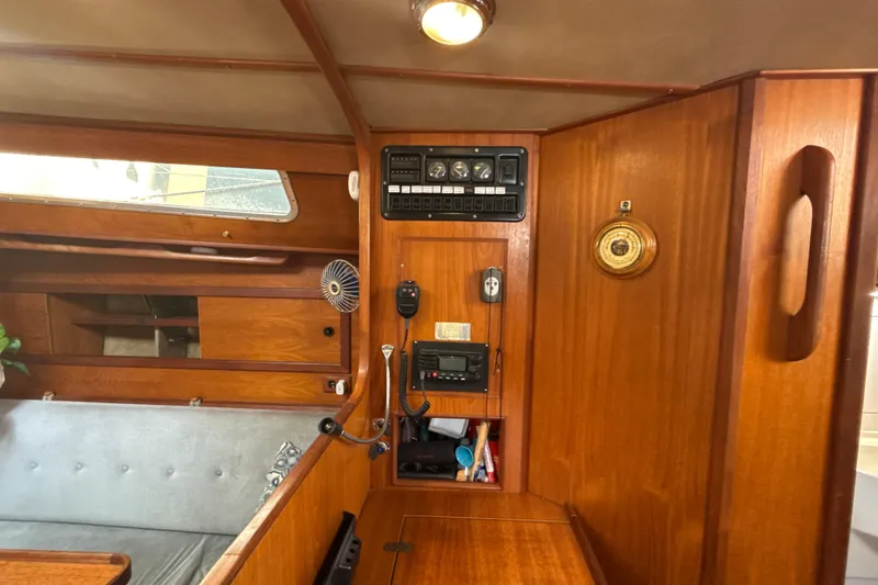 Slide: The Image of Interior of a 1985 Dehler 372 sailboat with wooden paneling and navigation equipment. - 27