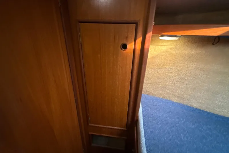 Slide: The Image of Interior of 1985 Dehler 372 yacht with wooden paneling and cozy cabin lighting. - 32