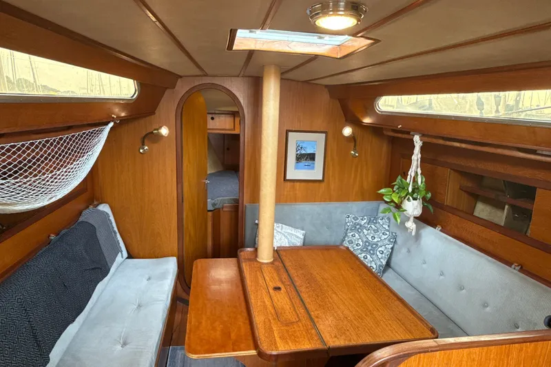 Slide: The Image of Interior of a 1985 Dehler 372 sailboat with cozy seating and wooden finishes. - 36