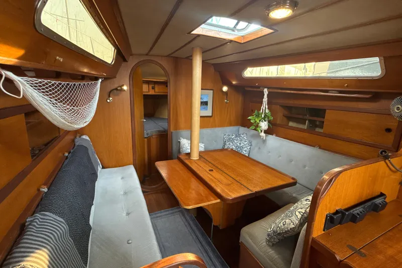 Slide: The Image of Interior of 1985 Dehler 372 sailboat with wooden furnishings and cozy seating area. - 37