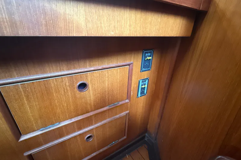 Slide: The Image of Wooden interior of 1985 Dehler 372 yacht with control panels and drawers. - 38