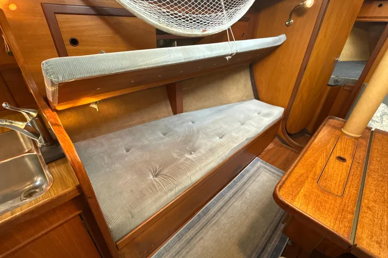 Slide: The Image of Interior of 1985 Dehler 372 sailboat with wooden furnishings and cushioned seating. - 39