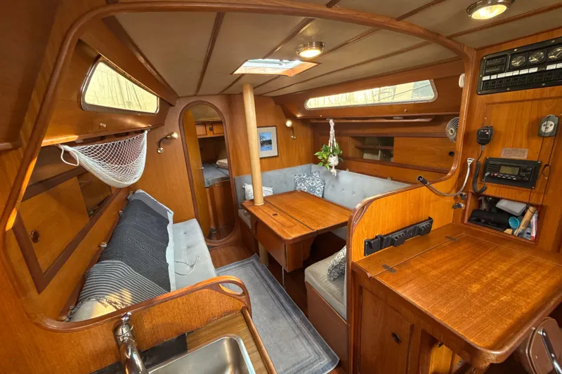 Slide: The Image of Interior of 1985 Dehler 372 sailboat with wooden furnishings and cozy seating area. - 4