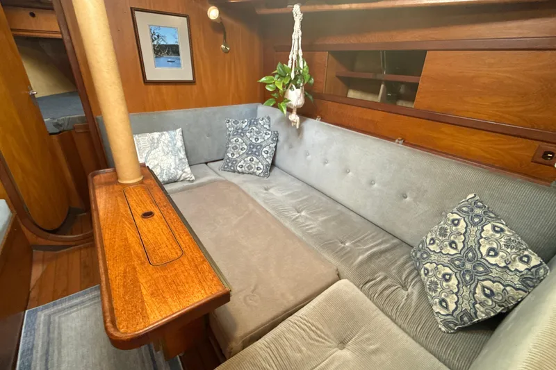 Slide: The Image of Cozy interior of 1985 Dehler 372 sailboat with plush seating and wooden accents. - 41