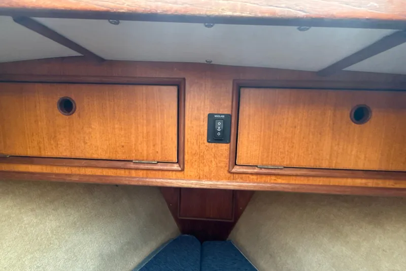 Slide: The Image of Interior of 1985 Dehler 372 sailboat with wooden cabinets and windlass control. - 43