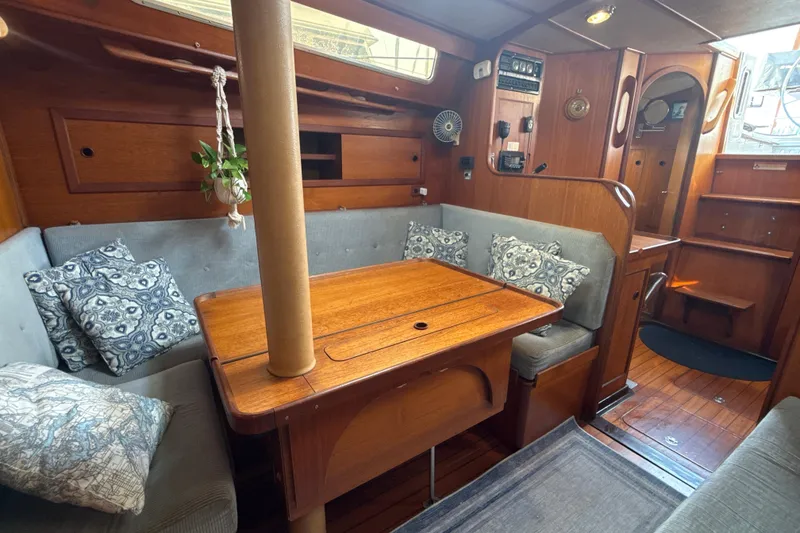 Slide: The Image of Interior of 1985 Dehler 372 sailboat with cozy seating and wooden table. - 6