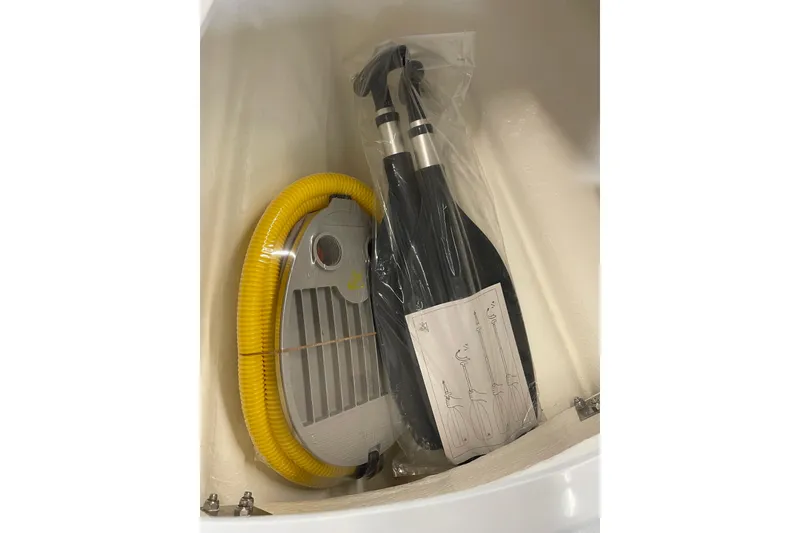 Slide: The Image of Zodiac Open 4.2 boat accessories, including yellow hose and paddles, 2026 model. - 7