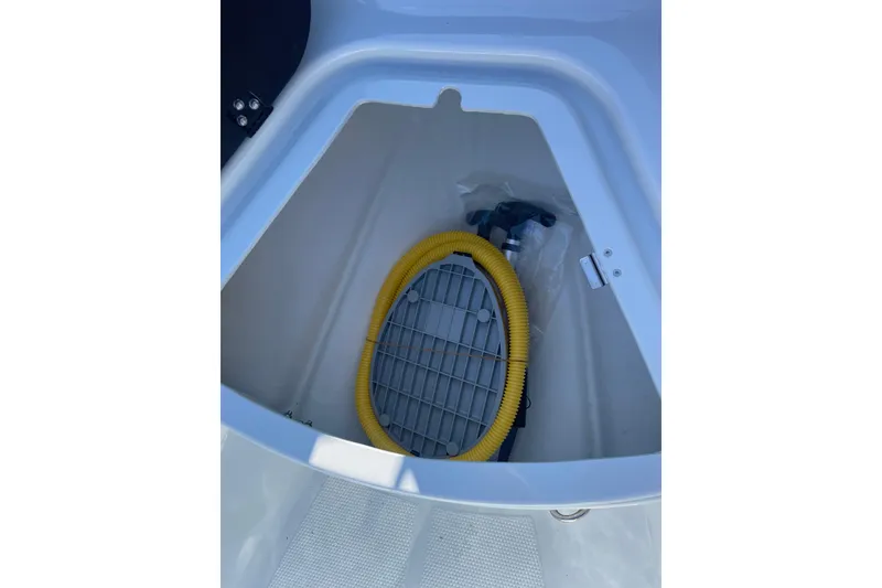 Slide: The Image of 2026 Zodiac Open 4.2 boat storage compartment with yellow hose and accessories. - 8