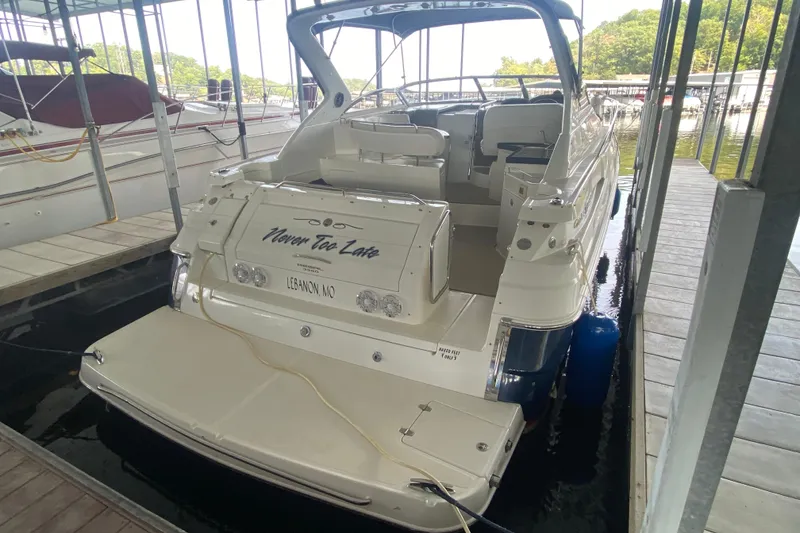 Slide: The Image of 2004 Regal Commodore 3560 boat docked, rear view, with "Never Too Late" text. - 11