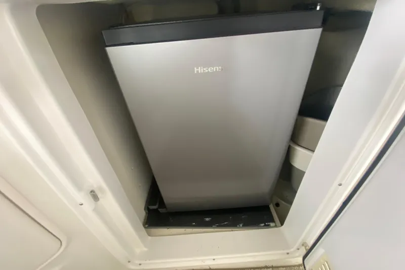 Slide: The Image of Compact Hisense refrigerator inside 2004 Regal Commodore 3560 boat compartment. - 14
