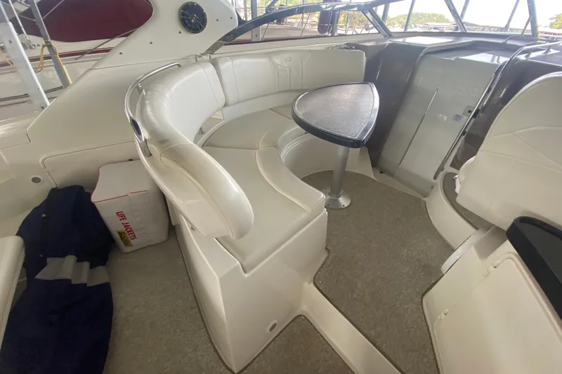 Slide: The Image of 2004 Regal Commodore 3560 interior with white seating and a small table. - 17