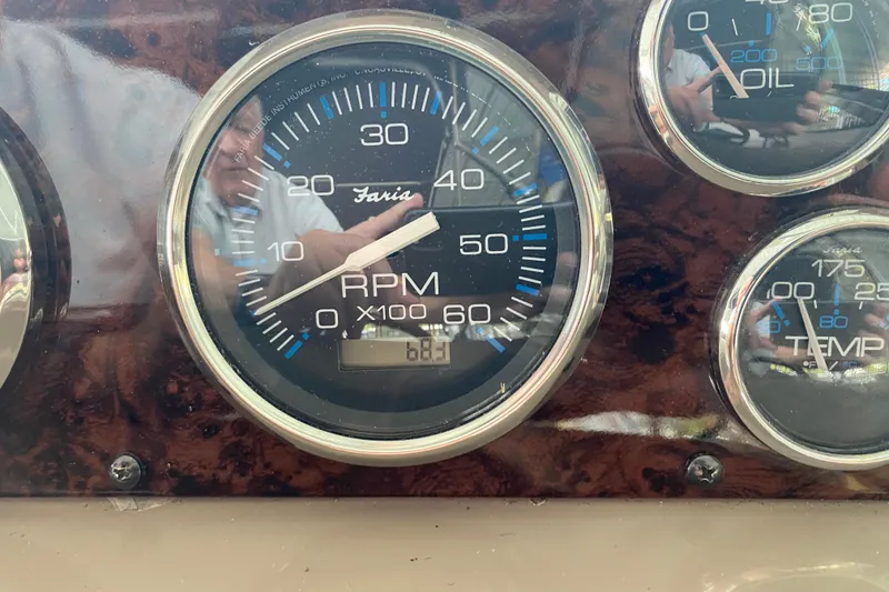 Slide: The Image of Close-up of 2004 Regal Commodore 3560 dashboard gauges, showing RPM, oil, and temperature. - 19