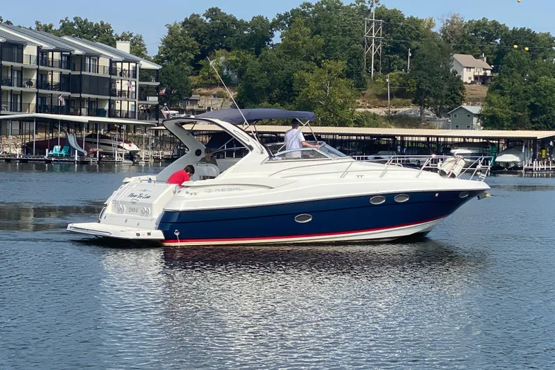 Slide: The Image of 2004 Regal Commodore 3560 yacht docked near waterfront buildings. - 2
