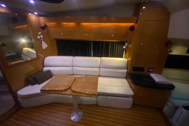 Slide: The Image of Interior of 2004 Regal Commodore 3560 yacht with cozy seating and wooden accents. - 28