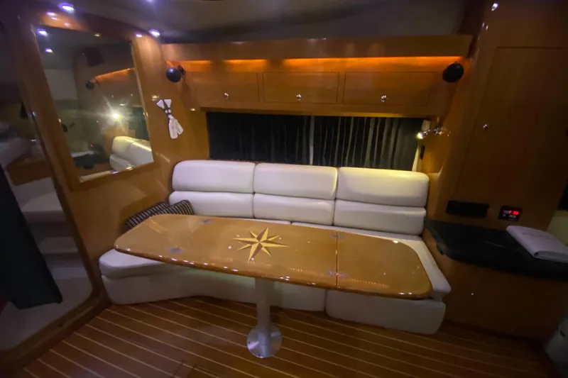 Slide: The Image of Luxurious interior of 2004 Regal Commodore 3560 yacht with elegant seating and wooden table. - 29