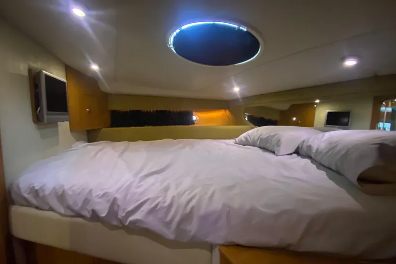 Slide: The Image of Cozy cabin interior of 2004 Regal Commodore 3560 yacht with bed and porthole. - 35