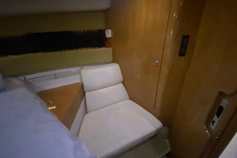 Slide: The Image of Interior of 2004 Regal Commodore 3560 yacht with white seating and wooden paneling. - 36