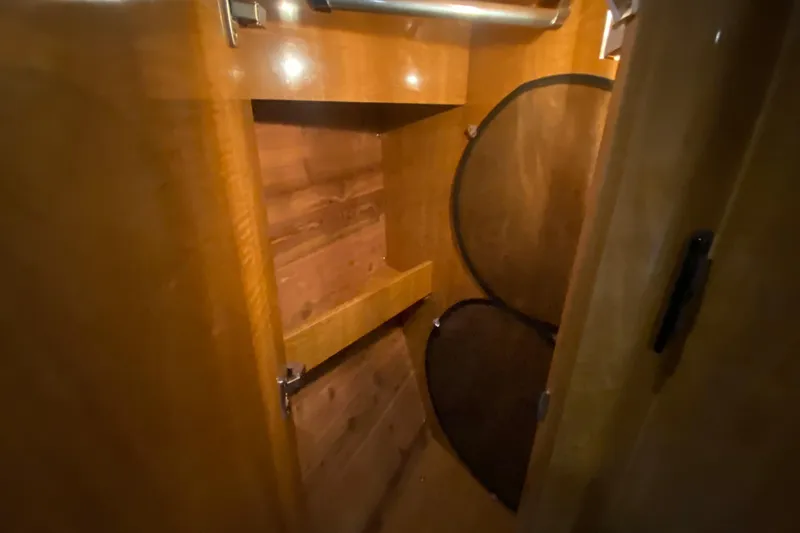 Slide: The Image of 2004 Regal Commodore 3560 interior wooden cabinet with shelves and storage space. - 37