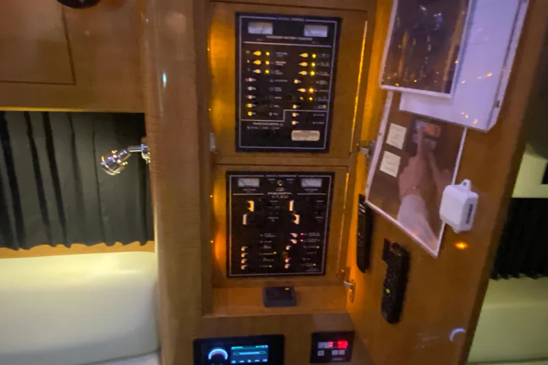 Slide: The Image of Control panel inside a 2004 Regal Commodore 3560 yacht, featuring illuminated switches and displays. - 39