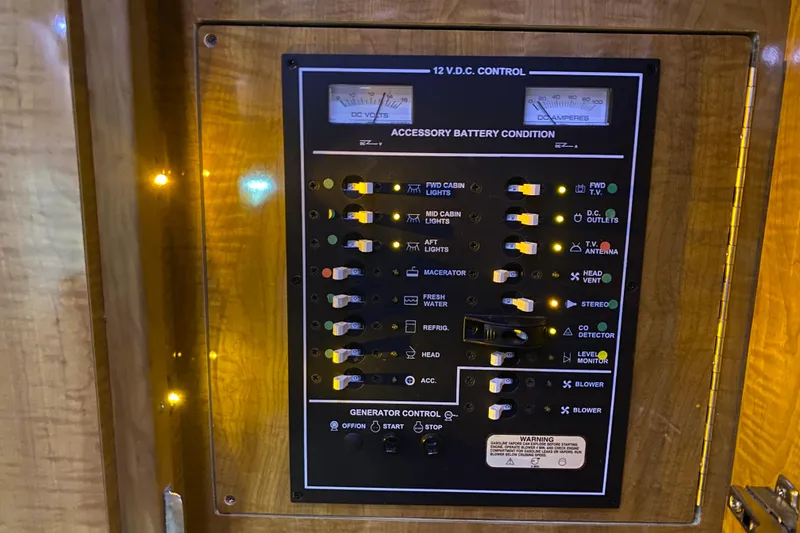 Slide: The Image of 2004 Regal Commodore 3560 control panel with switches and gauges for various boat functions. - 40