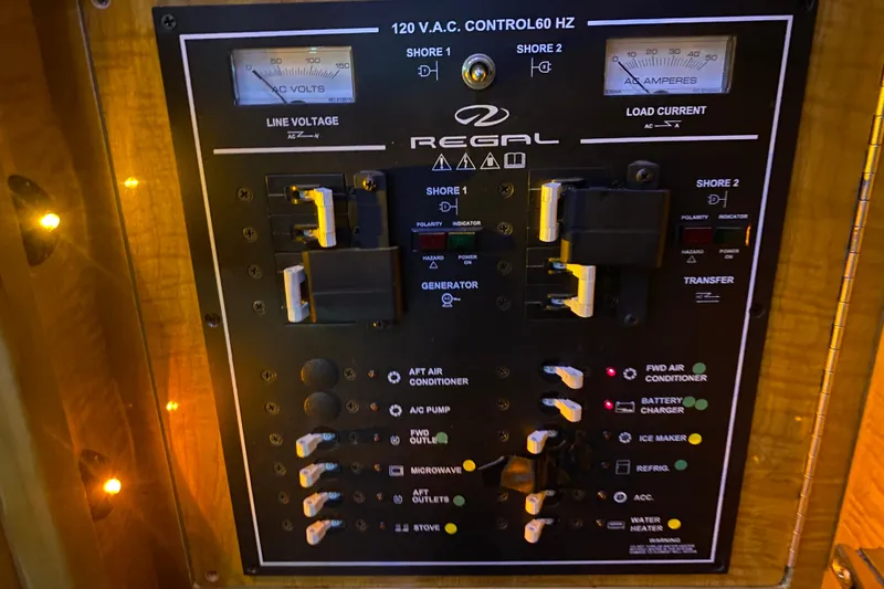 Slide: The Image of Electrical control panel of 2004 Regal Commodore 3560 boat with switches and indicators. - 41
