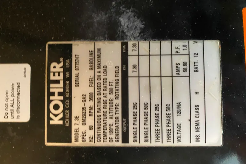 Slide: The Image of Label on Kohler generator, model 7.3E, gasoline, specifications and safety instructions. - 50