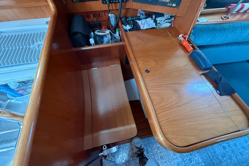 Slide: The Image of Interior of a 2001 Beneteau 361 sailboat with wooden cabinetry and seating. - 11