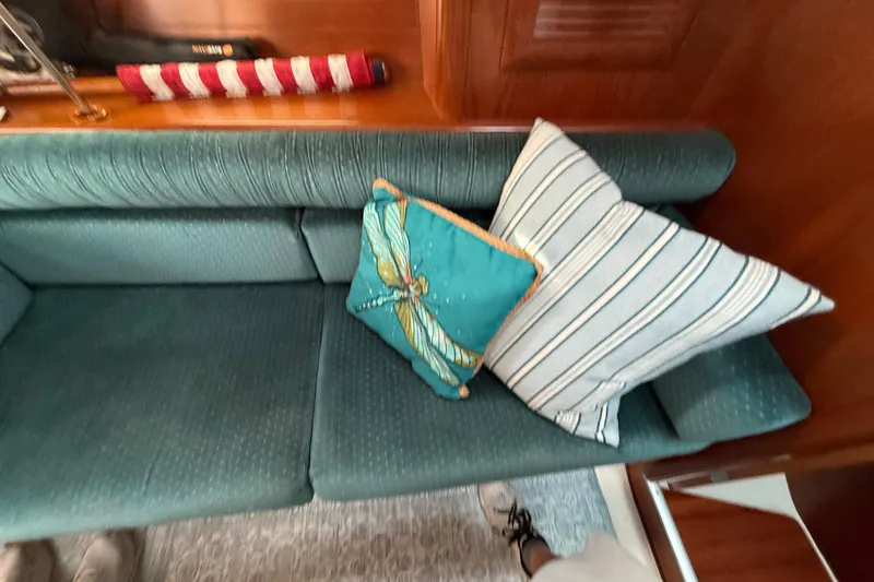Slide: The Image of Interior of 2001 Beneteau 361 yacht with teal cushions and decorative pillows. - 15