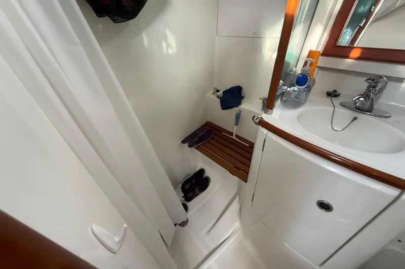 Slide: The Image of Beneteau 361 (2001) yacht bathroom with sink, shower, and wooden accents. - 18