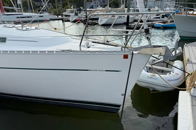 Slide: The Image of 2001 Beneteau 361 sailboat docked in a marina with inflatable dinghy. - 3