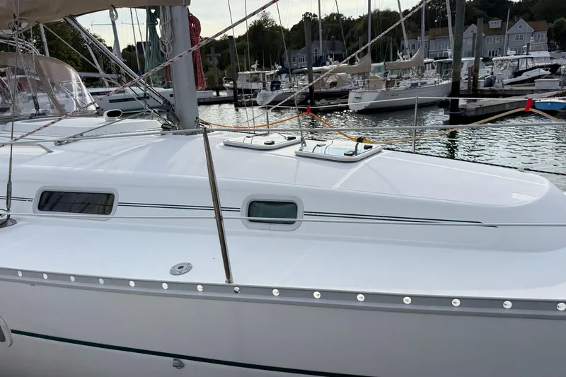 Slide: The Image of Sailboat Beneteau 361, 2001 model, docked at marina with other boats in background. - 4