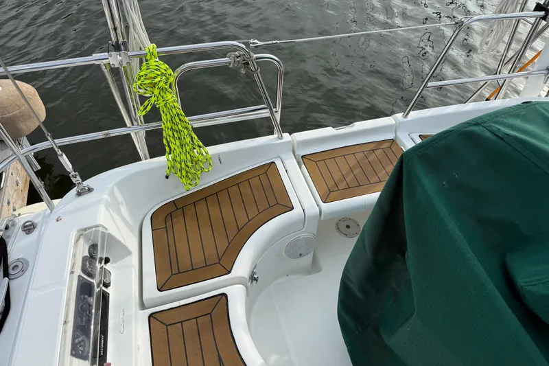 Slide: The Image of Cockpit of 2001 Beneteau 361 sailboat with teak flooring and green cover. - 5